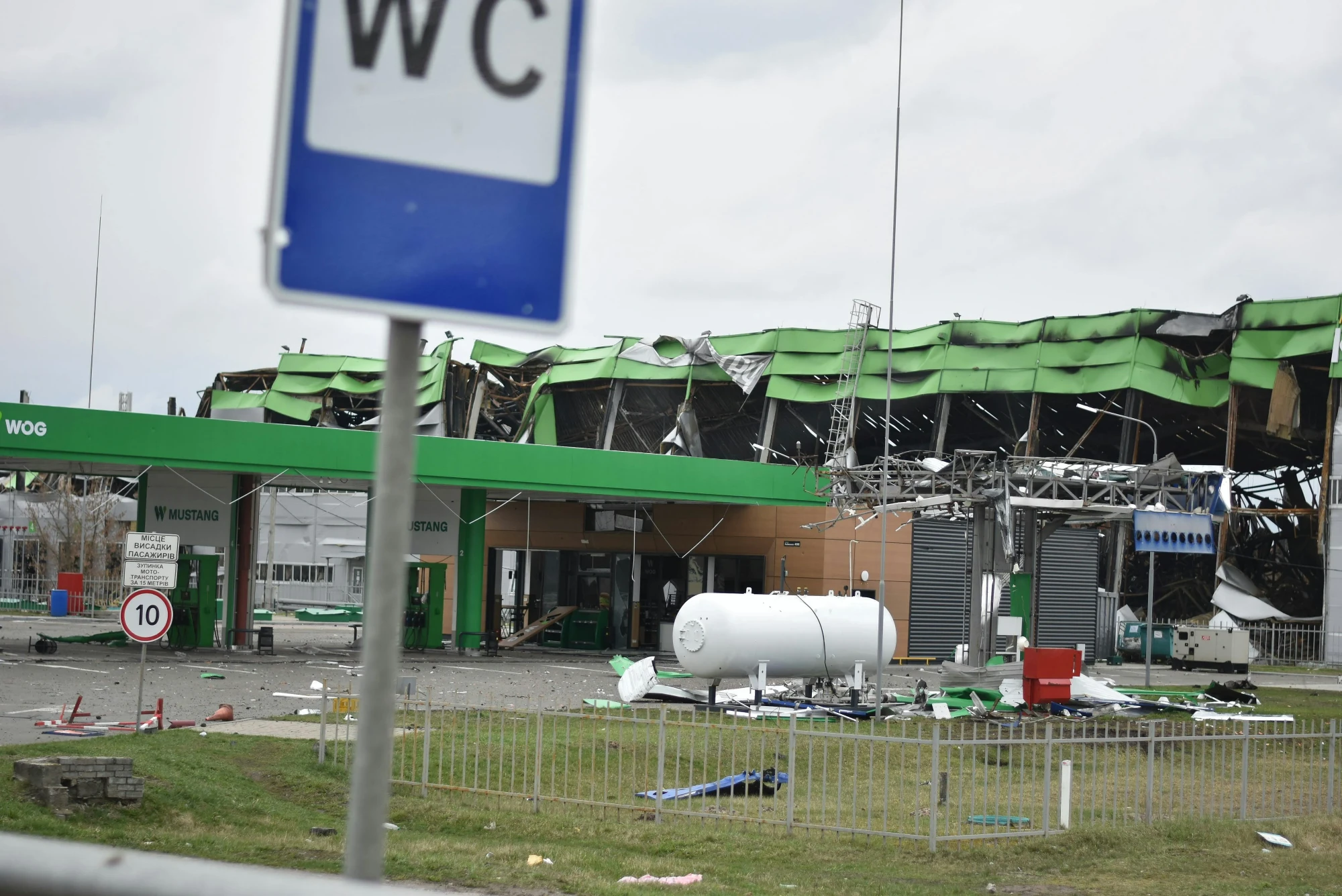 Zwaar beschadigd tankstation langs de weg in Oekra&iuml;ne