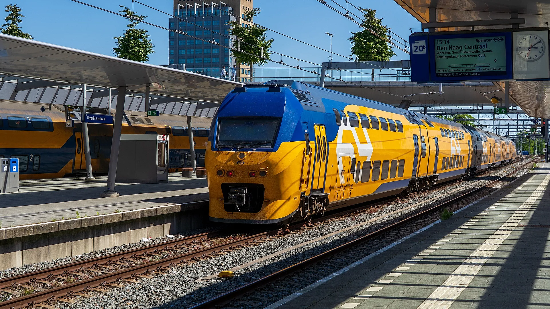 Gele NS-intercity langs een perron